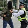 Peaceful pink-wearing mothers' migrants protest turns to violence: Masked men hijack demonstration, trying to rush gates at asylum seekers hotel before police crack down