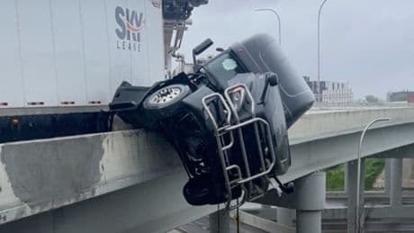 Terrifying moment trucker calls 911 while in his cab hanging off a bridge