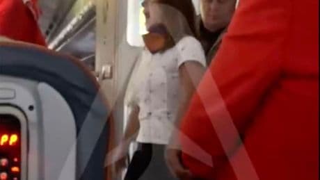 Wild moment furious female plane passenger has mid-air meltdown demanding business class upgrade