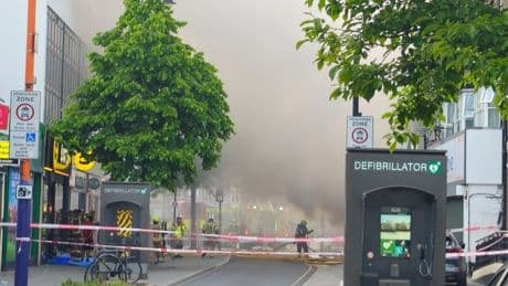 Huge fire at shop in East London fills the sky with smoke