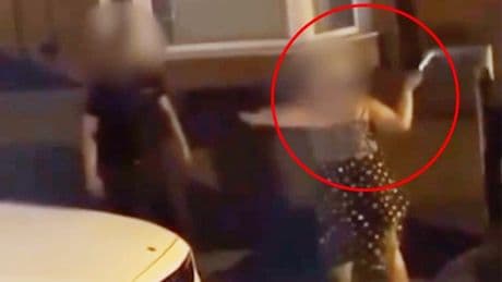 Woman caught on camera waving knife and yelling racist abuse at man on street