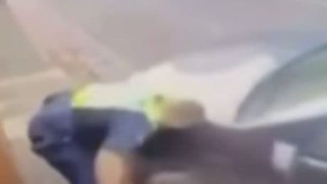 Terrifying moment screaming cop is forced to shoot woman driver dead after being left crushed against wall by stolen car