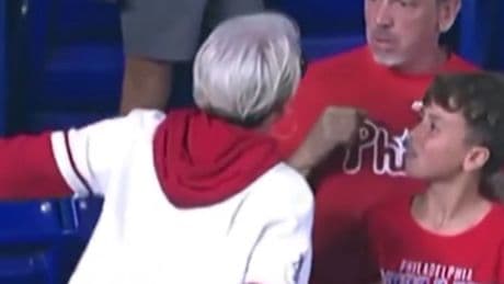 Angry Phillies fan slammed for snatching home run ball from young boy after she chased down his dad