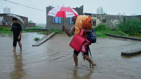 Photos show people fleeing flooding in Kashmir after weeks of intense rain in the region