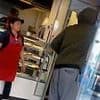 'I'm hungry': Alleged thief's astonishing reaction as he calmly raids shop in Dalston and walks out with snacks as helpless staff watch on