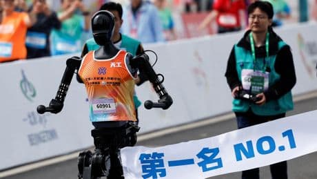 Robots race half-marathon against humans for first time, one falls over