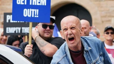 Opposing sides chant and shout outside asylum hotel in Perth