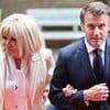 Emmanuel Macron puts on a brave face walking arm-in-arm with Brigitte after his team tried to deny his wife shoved him and he played down 'squabble' by comparing it to 'crackpot' cocaine rumours