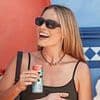 Margot Robbie looks incredible in a black mini dress as she hosts a pool party at Glastonbury