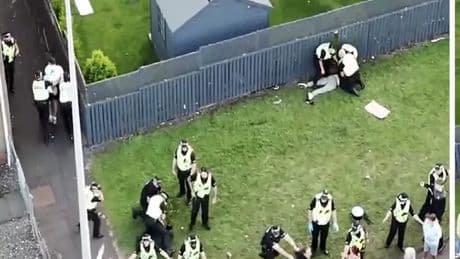 Five arrested after angry mob clash with police in street protest amid 'beast' chants