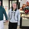 Chris Hughes sweetly welcomes JoJo Siwa back to the UK with a bunch of red roses as the pair leave Heathrow hand in hand after confirming romance