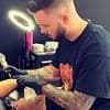 Revealed: Sick ex-Met cop who took selfies with the bodies of two murdered sisters is free from jail... and working as a tattoo artist