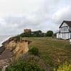 Widow, 88, fears her house could fall off cliff as erosion drags her street towards the sea - while neighbours fight to save their £1million homes
