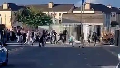 Masked hooligans shoot flares and chuck iron slabs in violent football clash