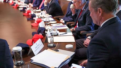 Photo appears to show now-former national security advisor Mike Waltz checking Signal during a Cabinet meeting