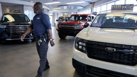 Ford shares slide as automaker takes $800M hit from tariffs, cuts profit forecast