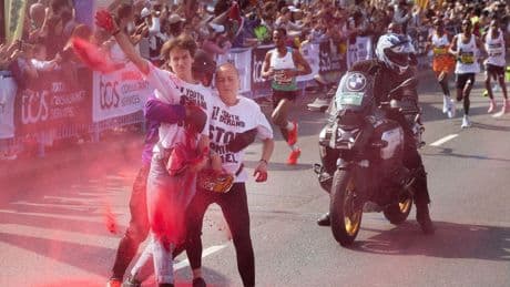 Protesters throw powder on Tower Bridge during London Marathon