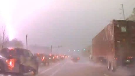Bolt of lighting hits transformer by busy highway causing huge fireball in dramatic footage