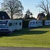 Boy, three, is seriously injured when hit by car towing caravan after travellers set up camp illegally on school playing field