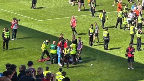 Footballer hit in the head by seat thrown from stands by own fans