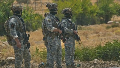 Kurdish separatist fighters in Iraq begin laying down weapons as part of peace process with Turkey