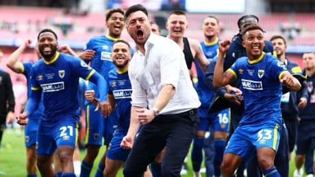 AFC Wimbledon seal promotion to League One as Guitar Hero joins Crazy Gang folklore