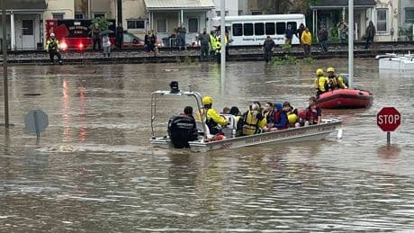 150 students and 50 adults are rescued from elementary school after flood waters consume town