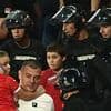 Riot police rush into stands as Serbia fans fight EACH OTHER in front of terrified children during England match