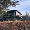Airbnb owner is ordered to tear down 40ft 'prison camp watchtower' from his garden after neighbour complained