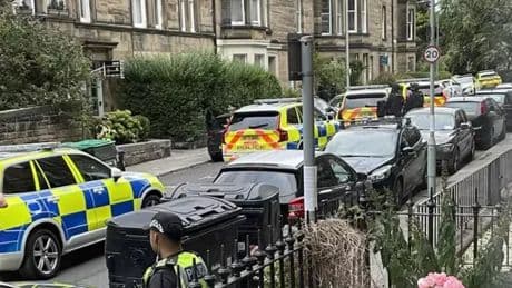 Armed cops storm Edinburgh street as man arrested and rushed to hospital