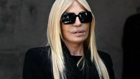 Donatella Versace's sombre figure as she pays respect to Giorgio Armani