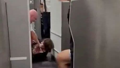 Moment flight attendant throws passenger to floor during 'bid to enter cockpit'