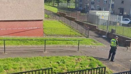 Police lock down large Glasgow estate after man found injured