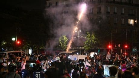 Masked fans hurl fireworks at riot police in Champions League final clash
