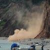 Moment huge rockfall narrowly misses sunbathers as 'thousands of tons' of cliff stone crashes down onto beach