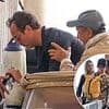 Jude Law, 51, takes a tumble and nearly drops his laptop in the water while stepping off a boat in Venice