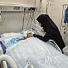 Doctor still fighting for his life after Israeli strike killed nine of his 10 children - as heartbreaking snap shows wife at his bedside