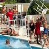 Shocking moment woman is knocked out after being hit in the head with a chair while brawl breaks out at an Ibiza hotel poolside