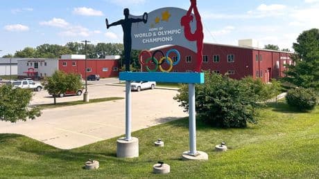 Years after abuse reports, ex-coach at renowned US gymnastics academy is arrested by FBI