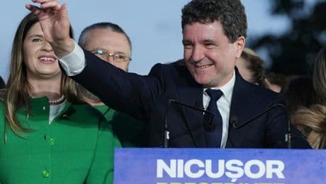 AP PHOTOS: Pro-EU centrist wins Romania’s tense presidential race over hard-right nationalist