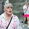 Suzy Eddie Izzard, 63, dresses for the heatwave in a bright pink miniskirt and a white blouse as she heads out for a stroll in Soho