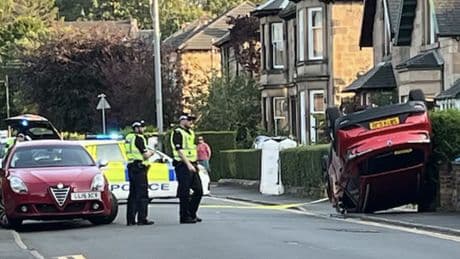 Glasgow road locked down after horror smash sees car flip onto roof