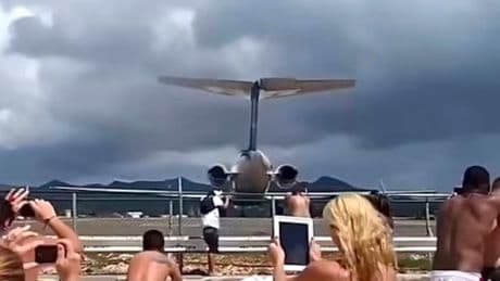 Dramatic moment tourists sent flying as plane takes off just metres away