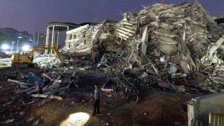 Thai construction magnate and others surrender to police on charges over building collapse in quake