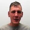 Father-of-two stabbed an armed intruder to death to protect his partner and children after masked gang burst into his home and started beating him: Five men are jailed