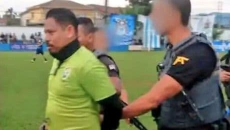 Football referee arrested mid-match as cops storm pitch in bulletproof vests