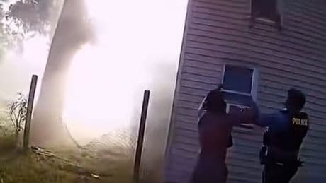Heart-stopping moment police catch child jumping from window of burning house