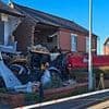 Moment JCB tractor veered off the road and crashed into a house after colliding with drug driver's Mercedes when it jumped red light