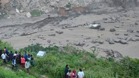 Monsoon floods sweep away 18 people and the main bridge linking Nepal to China