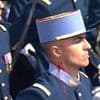 Moment bleeding soldier puts on a brave face during French Bastille Day celebrations as he continues marching with sword in hand